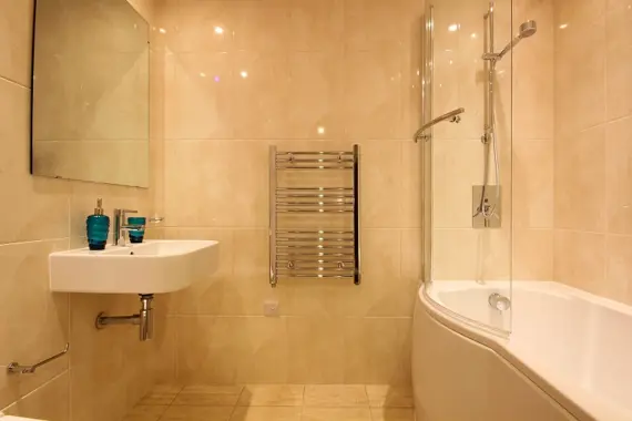 Towel heating radiator in bathroom