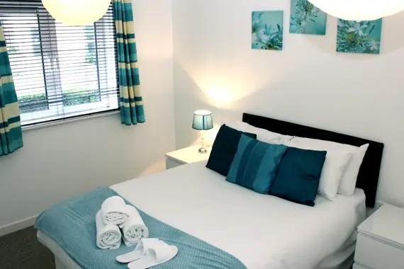 A bright, comfortable bedroom in a one bedroom apartment