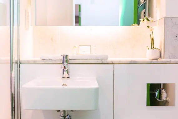 A well lit bathroom in a one bedroom apartment