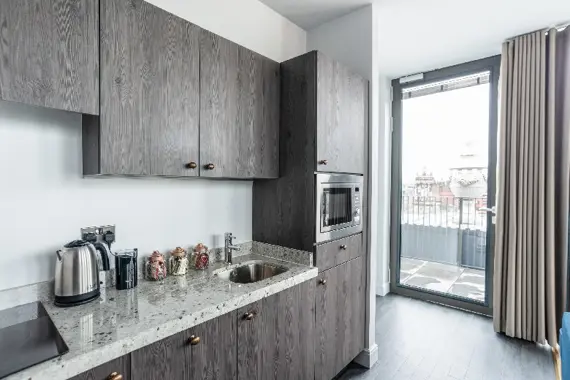 A fully equipped kitchen in the penthouse one bedrooms