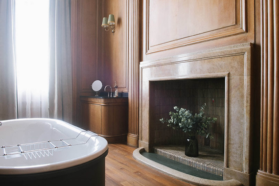 The bathroom with a fire place in the Director's Suite