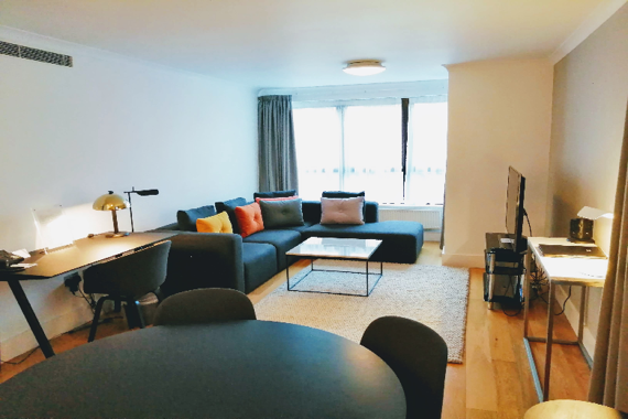 A spacious living area in Monarch House Apartments