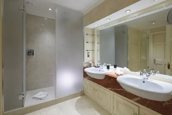 A spacious shower room with two basins