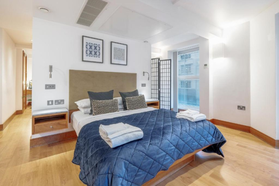 Modern and trendy bedroom showcasing sleek furniture.