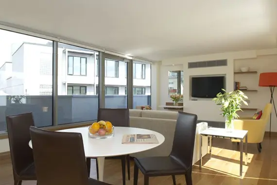 The spacious, modern lounge and dining area of the penthouse apartment