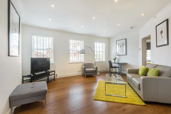 A modern open plan comfortable living area with a large flat screen TV