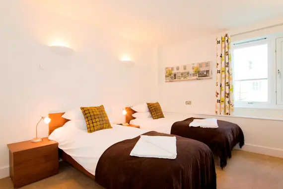A bright and comfortable twin bedroom at The Hamiltons