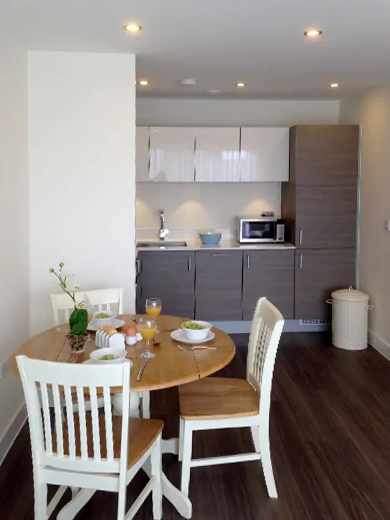 A modern, well equipped kitchen with cute dining area