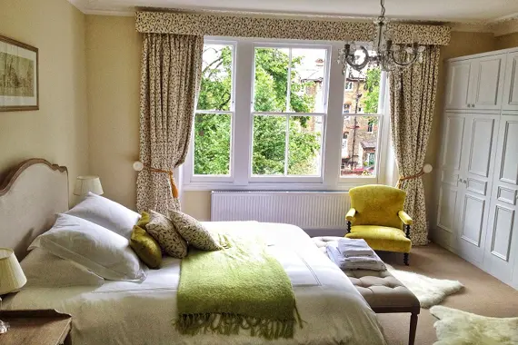 The large and bright Crescent bedroom overlooks the garden with a Feather and Black super-kingsize bed