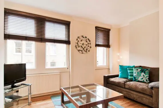 A bright and comfortable living area at Chiltern Street with a sofa and a flat screen television