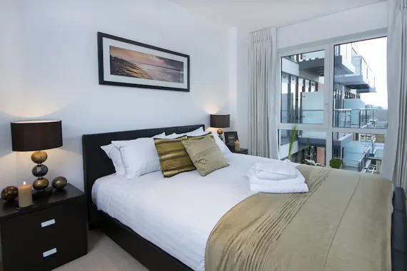A typical spacious double bedroom at Dickens Yard decorated in neutral colours