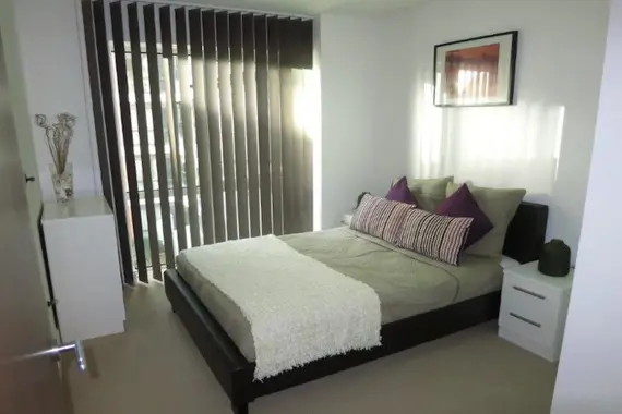 A typical comfortable double bedroom decorated in neutral colours