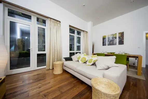 A bright and spacious living area at Kew Bridge Piazza with a large comfortable sofa