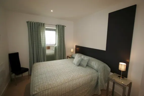 A comfortable and spacious double bedroom in a typical two bedroom apartment