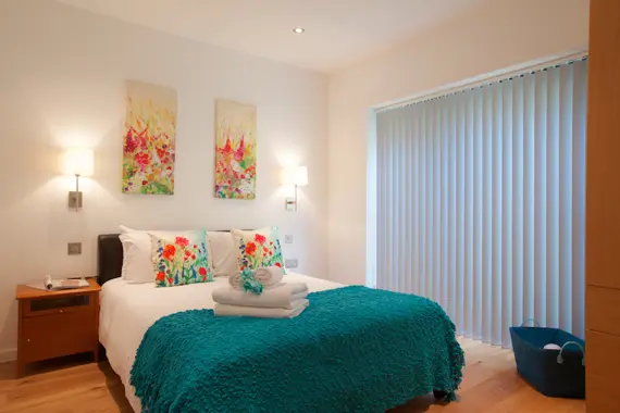 A comfortable and bright double bedroom