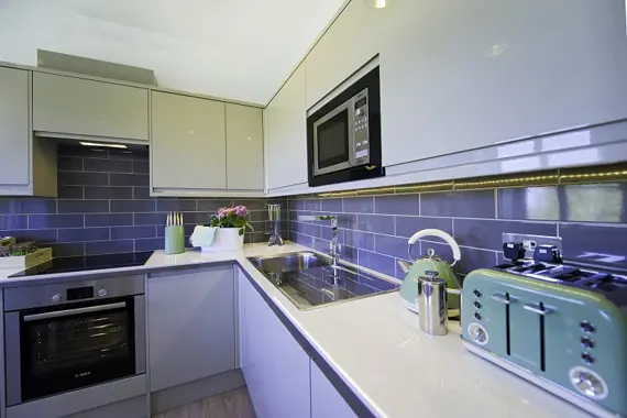 A newly fitted, sleek kitchen in the Court Suite