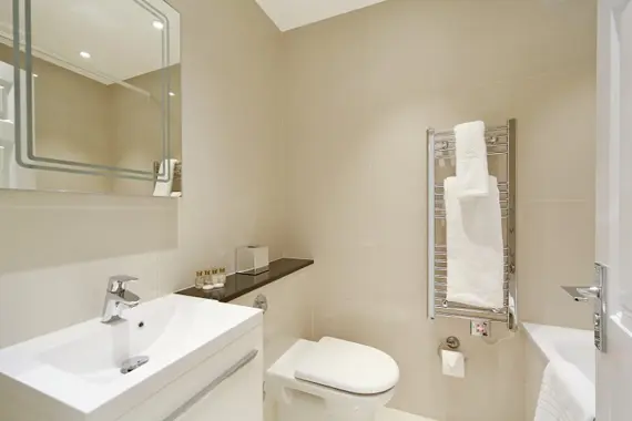 A spacious, modern bathroom in a three bedroom standard apartment