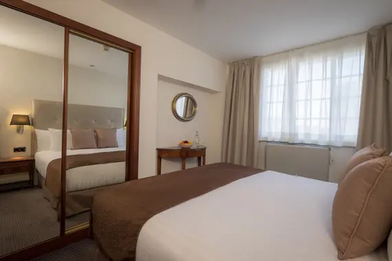 A cosy bedroom with ample storage in the one bedroom apartment